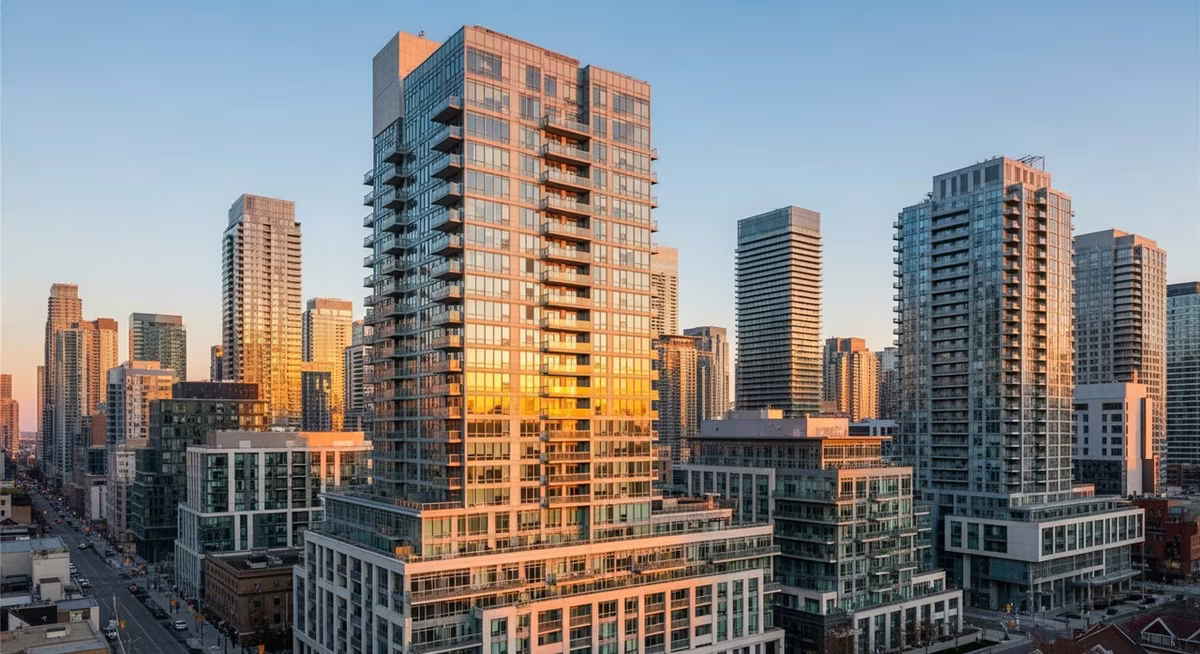 Toronto King West high-rise condo building exterior at golden hour viewed from across the street