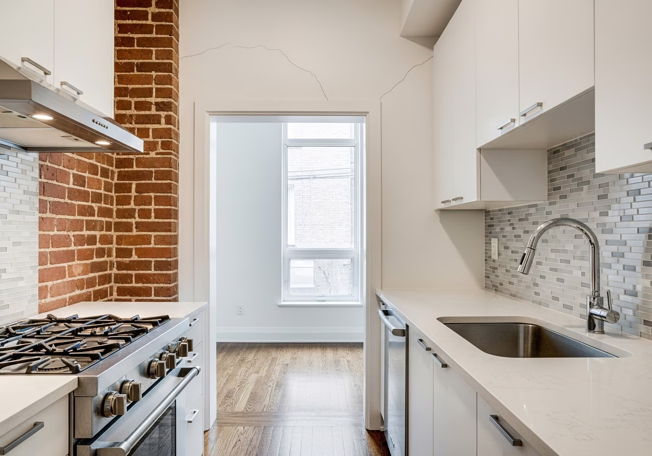 Settling cracks above doorway in Toronto Leslieville rowhouse kitchen — common Victorian-era issue