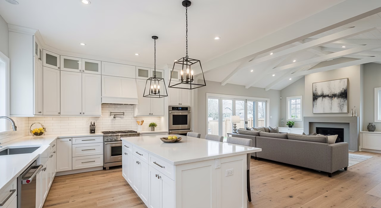 Completed Toronto home remodel main floor with peninsula opening kitchen to family room with oak floors