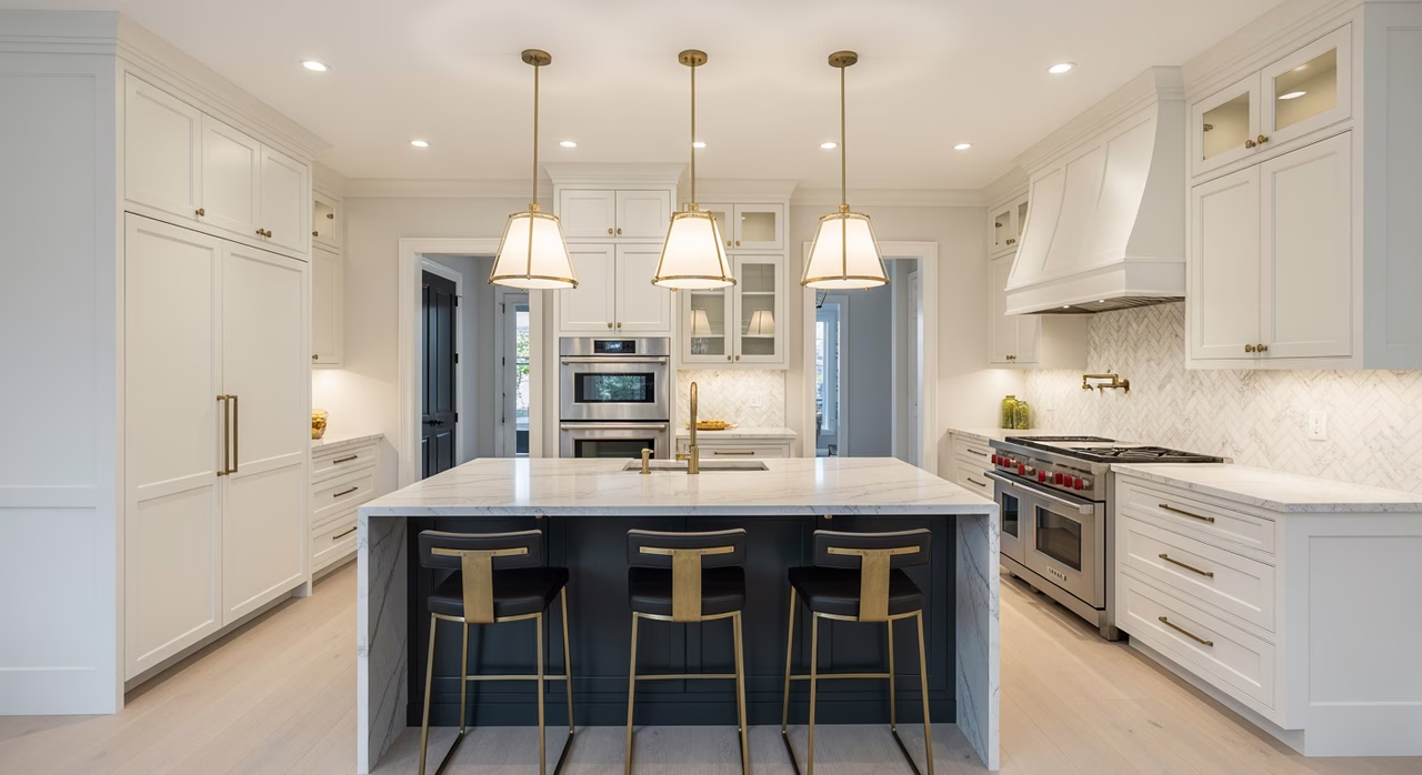 Completed Toronto luxury kitchen with full-height custom shaker cabinets, waterfall quartzite island, panel-ready Sub-Zero and Wolf range, marble herringbone backsplash